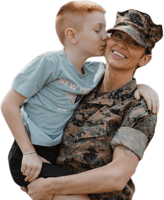 Service member holding a child, representing family support and stability