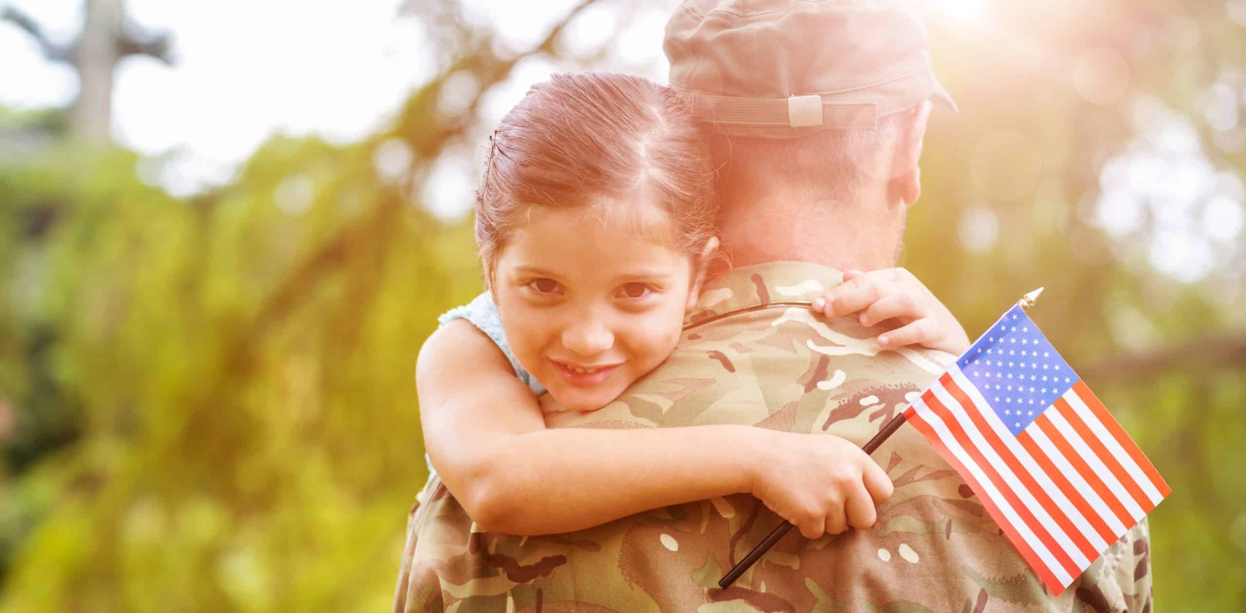 Portrait of girl hugging army officer father