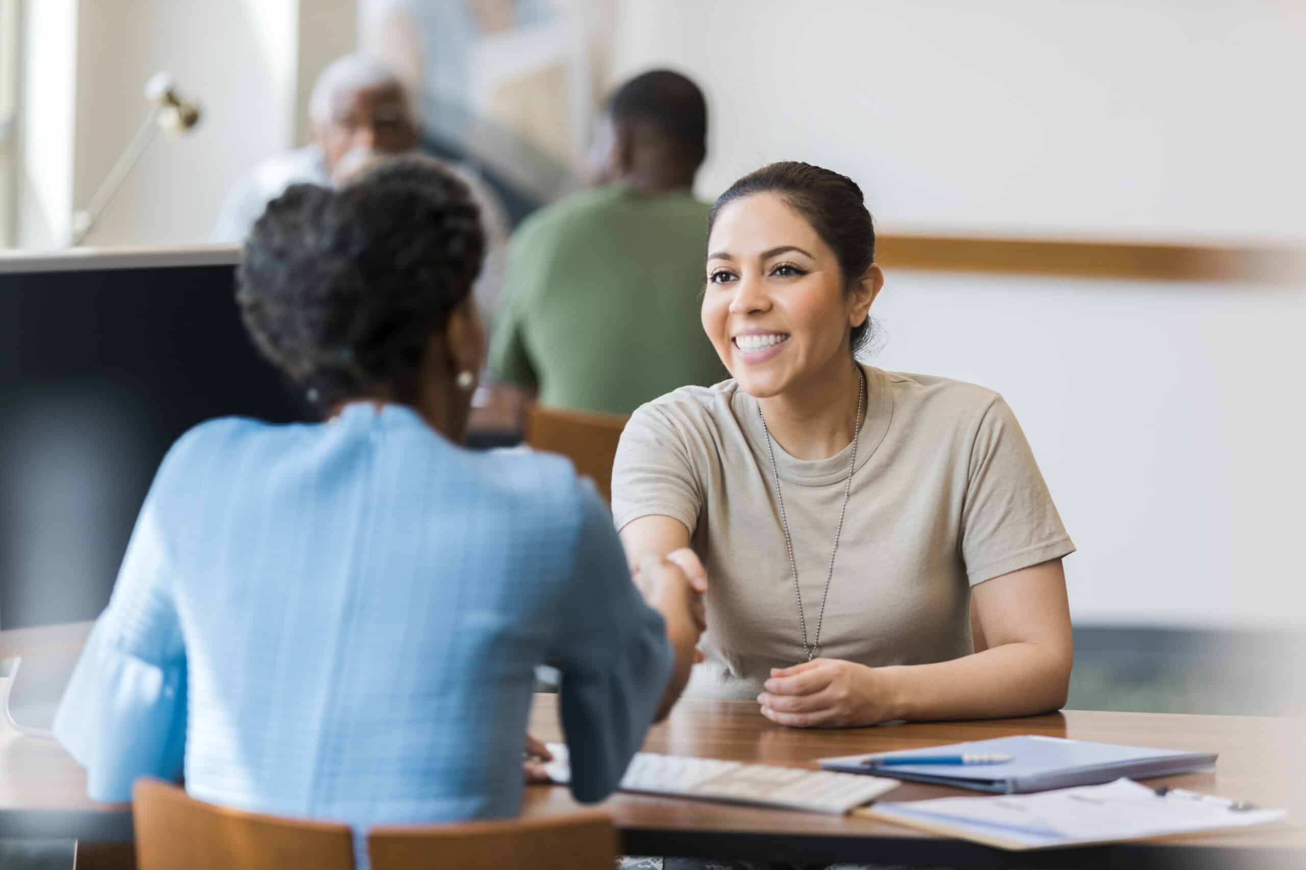 Cheerful females soldier greets bank manager