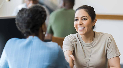 Employer representative speaking with a candidate during the hiring process