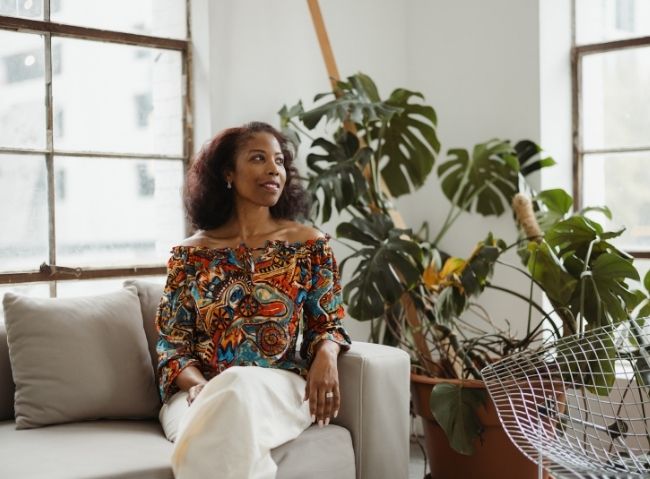 Woman seated indoors representing long-term support for veterans and military spouses