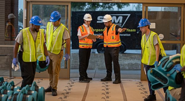 ServiceMaster Restore team members in hard hats during restoration training