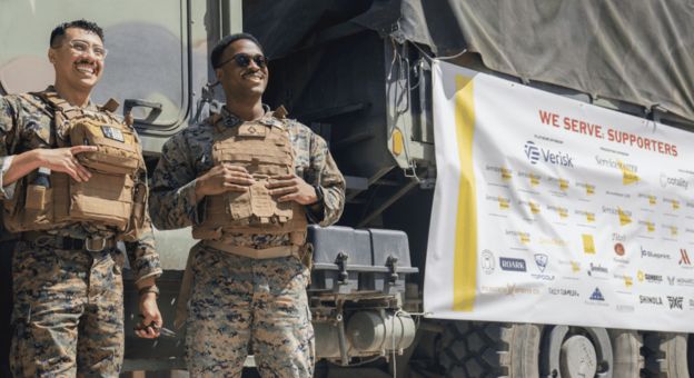 Service members reviewing a planning board during a military training exercise
