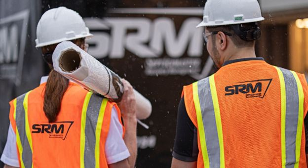 ServiceMaster Restore team members in safety gear at a restoration site